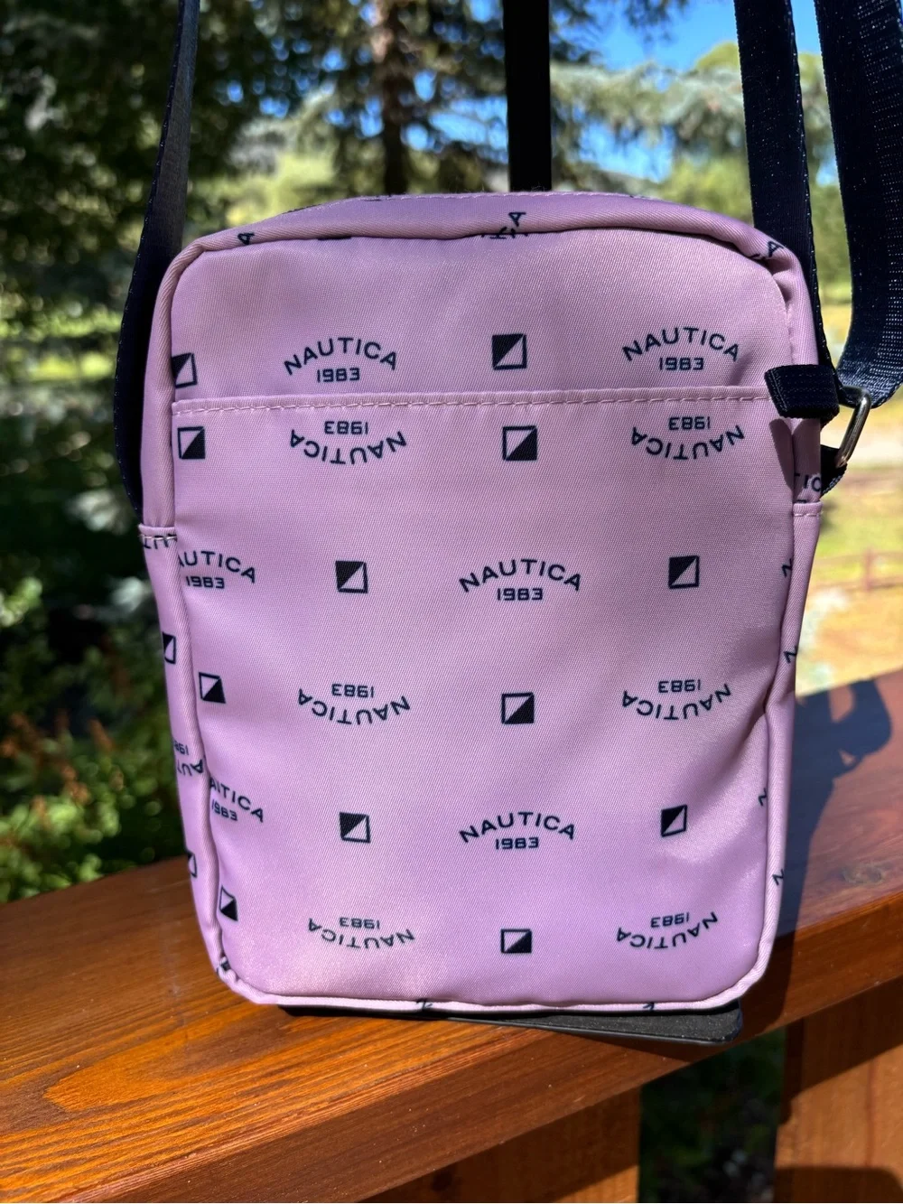 Nautica Pink Logo Print Crossbody Bag with Navy Strap and trim.